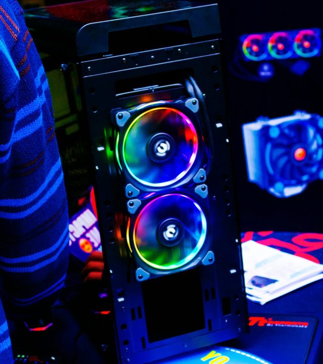 Close-up of a modern PC case featuring vibrant RGB LED fans, showcasing futuristic technology.